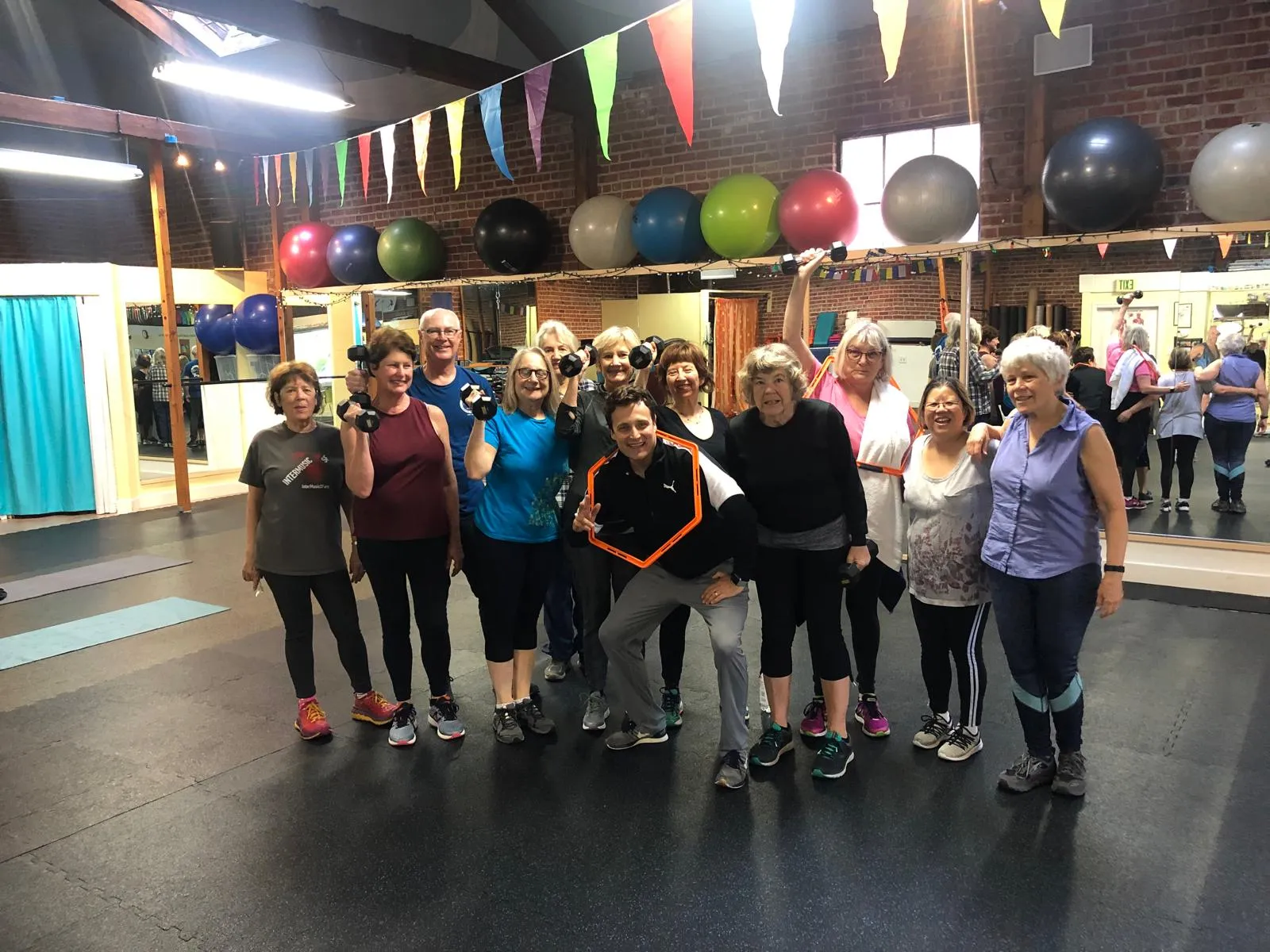 Group fitness class with dumbbells